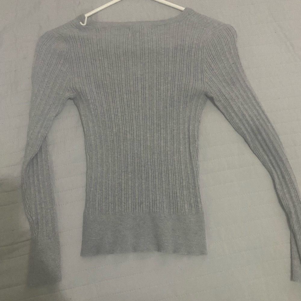 A grey stretchy long sleeve top
